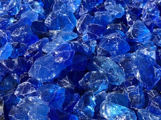 Close up of a pile of blue glass rock in a crate