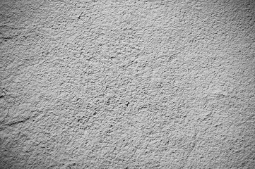 Beige wall texture background. Ribbed surface with holes and scratches.