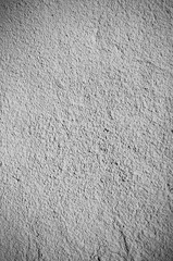 Beige wall texture background. Ribbed surface with holes and scratches.