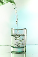 Pure water is poured into a glass beaker.