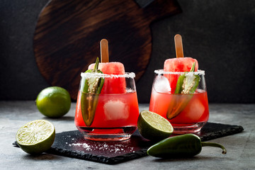Spicy watermelon popsicle margarita cocktail with jalapeno and lime. Mexican alcoholic drink for...
