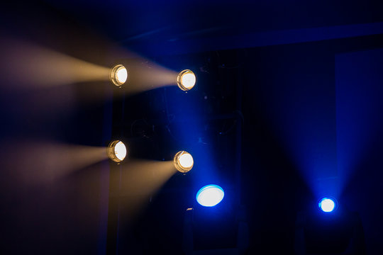 Theatre lighting equipment. The light rays from the spotlight through theatrical smoke.