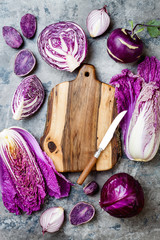 Seasonal winter autumn purple vegetables over gray stone table. Plant based vegan or vegetarian cooking concept. Clean eating food, alkaline diet