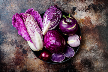 Seasonal winter autumn purple vegetables background. Plant based vegan or vegetarian cooking concept. Clean eating food, alkaline diet