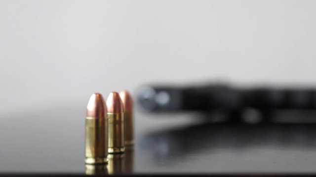 Bullets and 9mm gun Dolly macro shot of Bullets and 9mm gun