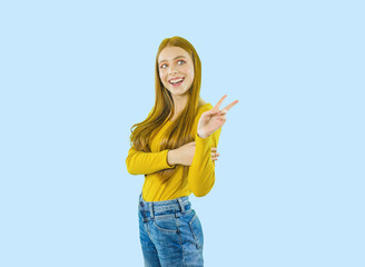 Portrait of a young beautiful red-haired woman standing in profile looking to the side and showing piss, shooting on an isolated background
