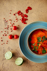 Tom Yam kung Spicy Thai soup with shrimp, seafood, coconut milk and chili pepper in bowl copy space