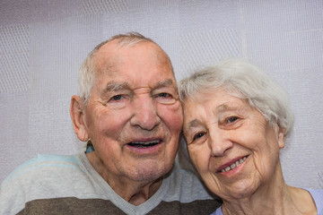 Happy affectionate mature old man and woman embracing