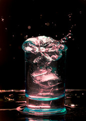 shot of whiskey with splash on black background