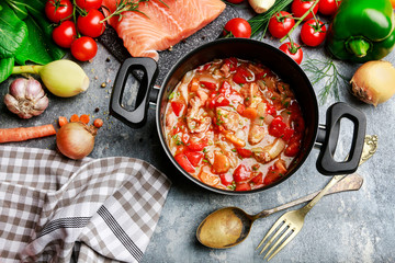 Goulash soup, salmon fillet and colorful vegetables