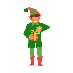 vector flat christmas elf boy holding present box with golden ribbon bow smiling. Fairy holiday character in hat, green costume, santa claus magic assistant. Isolated illustration