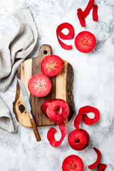 Still life with apples on wooden board over white marble table, top view. Fresh red apples Baya Marisa.