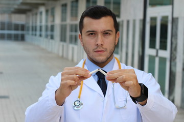 Upset doctor breaking a cigarette