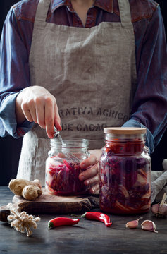 Cabbage Kimchi In Glass Jar. Woman Preparing Purple Cabbage And Watermelon Radish Kimchi. Fermented And Vegetarian Probiotic Food For Gut Health