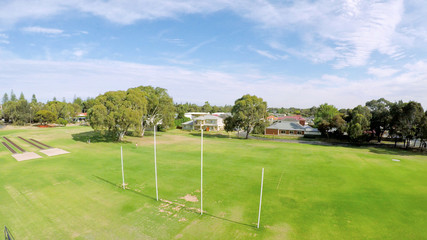 Drone aerial view of Australian public park and sports oval field, taken at Henley Beach.