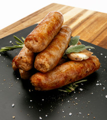 Seasoned tastey sausages with a garlic and herb garnish