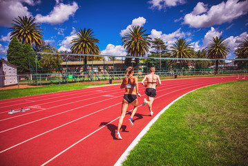 Athlete running on the track in summer day