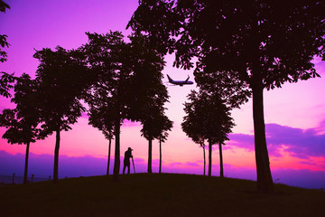 Photographer, Airplane and colorful sunset sky.