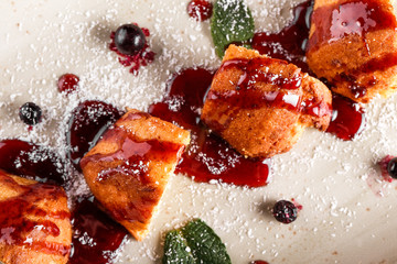 Homemade muffins with jam, blueberry and coconut in plate on dark stone background. Top view, Flat lay. Healthy breakfast