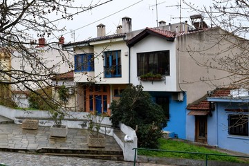 Fototapeta na wymiar Traditional colorful houses in Ano Poli district, Thessaloniki Greece in a rainy day. 