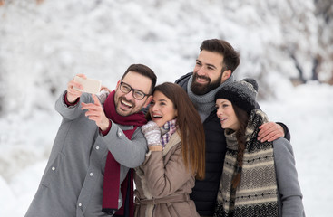 Friends taking selfie on snow