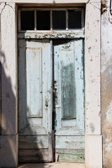 Fototapeta na wymiar Old shabby door in the sun