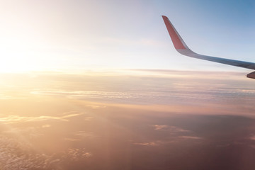Fototapeta na wymiar sunset through the window of an airplane