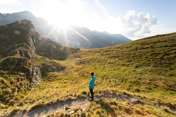 Fototapeta na wymiar Girl hiking through Fagaras mountains in Romania.