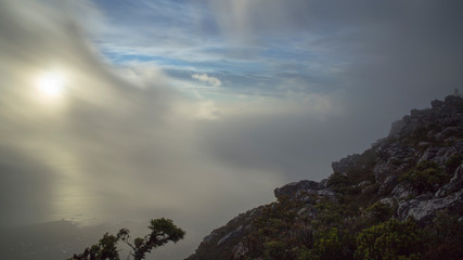 clouds over table mountain in south africa above cape town during sunset