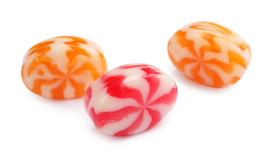 Different delicious colorful candies on white background