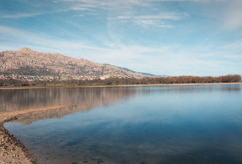 Mountains and trees reflected in the water of a lake