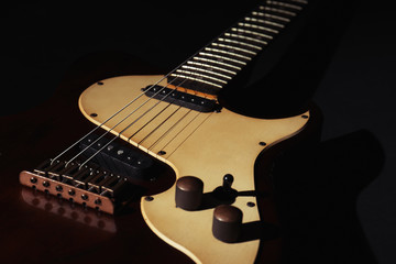 Fototapeta na wymiar Electric guitar on black background, closeup. Musical instrument