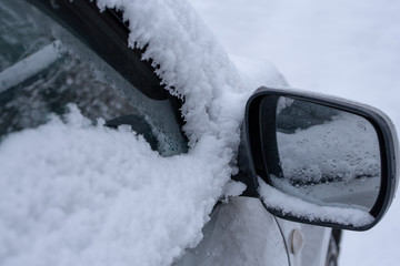 car fragment with side mirror in the snow