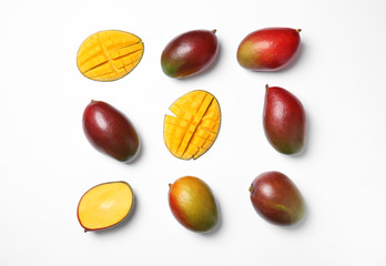 Tropical cut and whole mango fruits isolated on white, flat lay