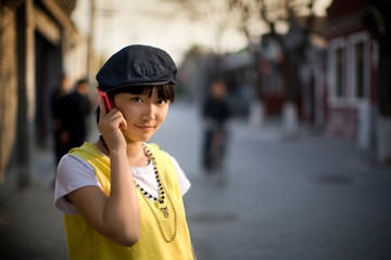 Portrait of a young adult woman talking on a cellphone.