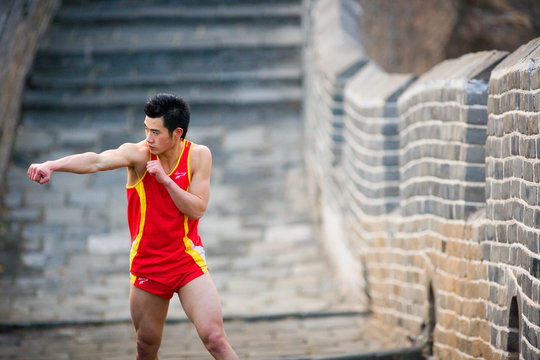 Chinese Olympian at the Great Wall of China.