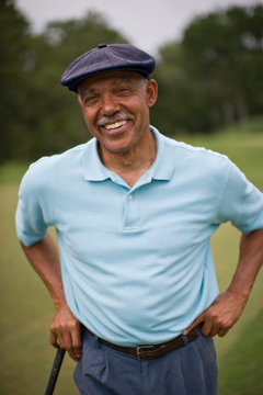 Portrait of a smiling senior man wearing a golf cap.