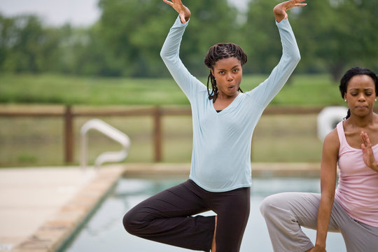 Portrait of two young woman doing yoga.