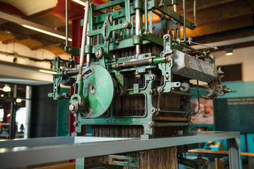 Fototapeta premium Close up old vintage metal weaving loom. The concept of historical development of weaving in England. Selective focus. Copy space.