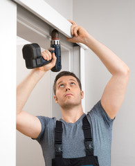 Handyman installing sliding door at home.