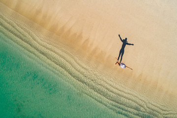 Aerial drone aerial view of Beautiful girl having fun on the sunny tropical beach. Seychelles