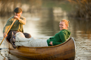 Portrait of a smiling young woman in a canoe with her boyfriend.