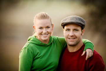 Portrait of a young adult couple outside.