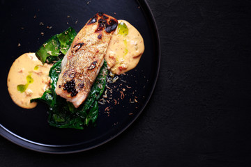 grill pub and fish restaurant menu, food photo art. delicious pikeperch with spinach garnishing and sauce, grilled zander