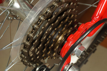 View of the red bicycle wheel, zooming in on the rear derailleur modes.