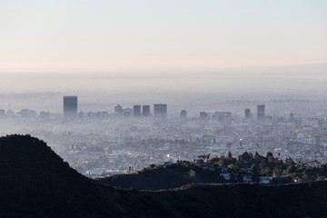 Foggy, smoggy morning skyline view of Los Angeles Mid City from popular Griffith Park near...