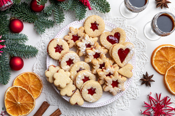 Linzer Christmas cookies arranged on a plate, top view