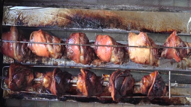 Roasted German pork hocks (knuckle) rotating grilled on fire, barbecue for sale in the gourmet market.Delicious tasty and High protein nutrition for healthy.Food,Business,Easter Concept.