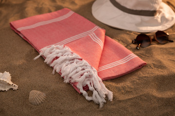 Handwoven hammam Turkish cotton towel on beach - obrazy, fototapety, plakaty