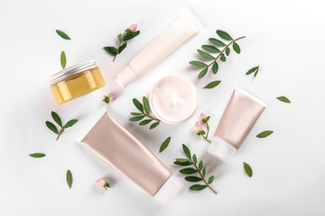 Moisturizing care skincare face cream for healing complicated troubled skin type in an open jar with visible texture. Copy space, close up, background, flat lay, top view. Eucalyptus leaf decoration.